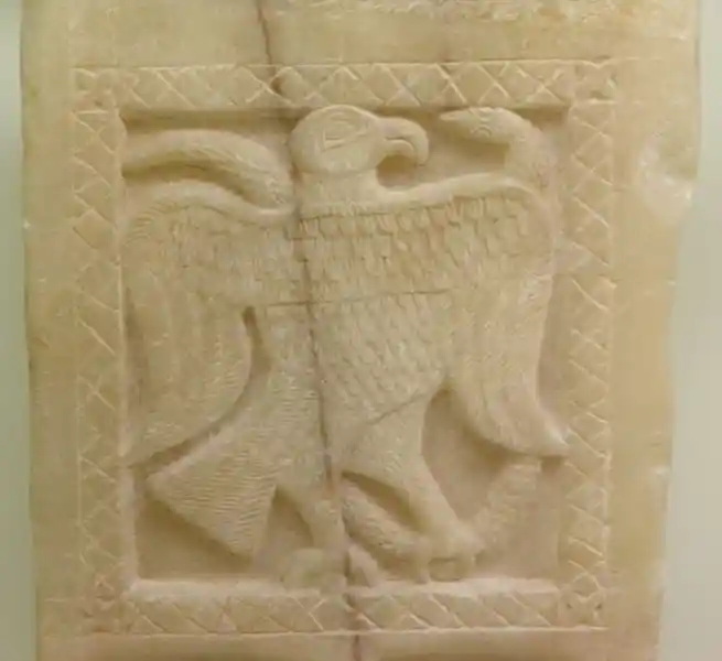 Eagle and snake carved on a marble clay with a square border